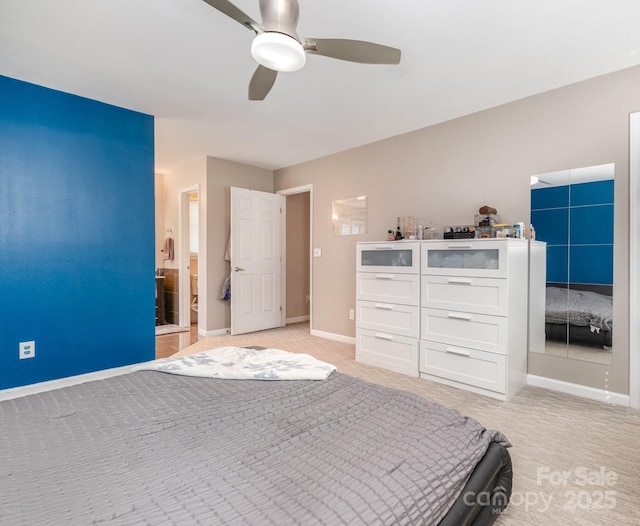 unfurnished bedroom with baseboards, a ceiling fan, and light colored carpet