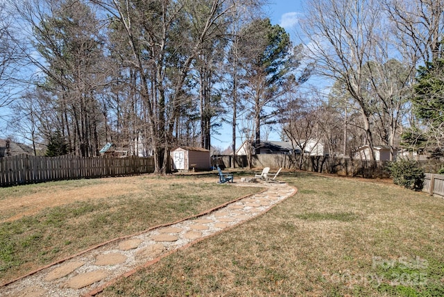 view of yard featuring a fenced backyard, an outdoor structure, and a storage shed