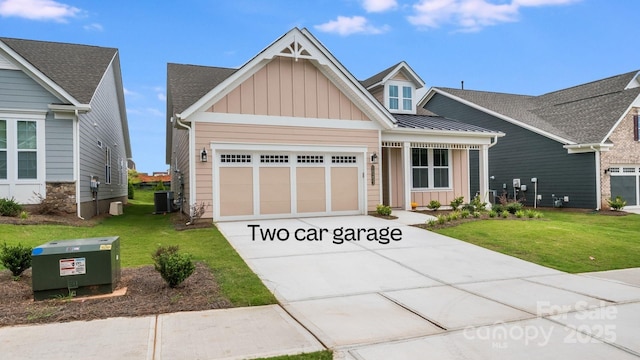 craftsman-style house featuring central AC unit, a garage, driveway, board and batten siding, and a front yard