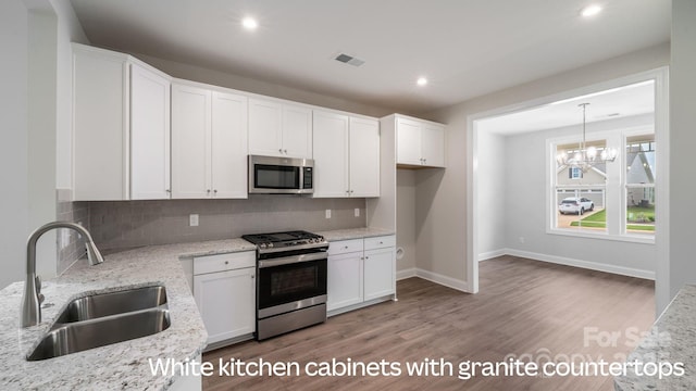 kitchen with white cabinetry, appliances with stainless steel finishes, and a sink