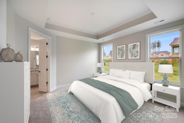 bedroom with multiple windows, a raised ceiling, and visible vents