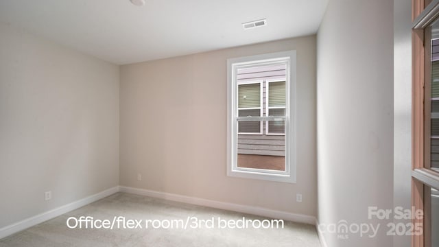 unfurnished room with visible vents, baseboards, a wealth of natural light, and light colored carpet