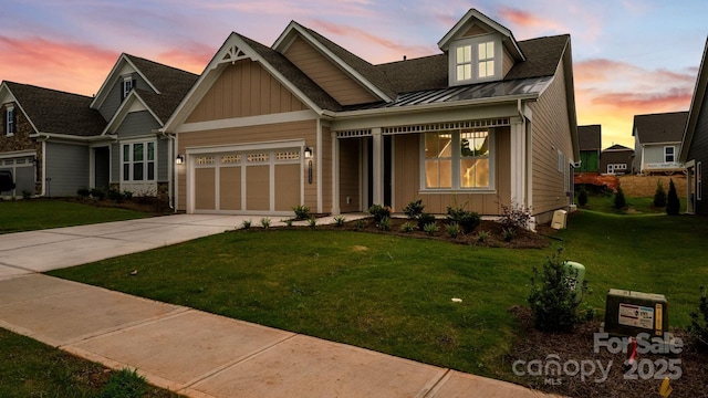 view of front of house with a yard, board and batten siding, and driveway