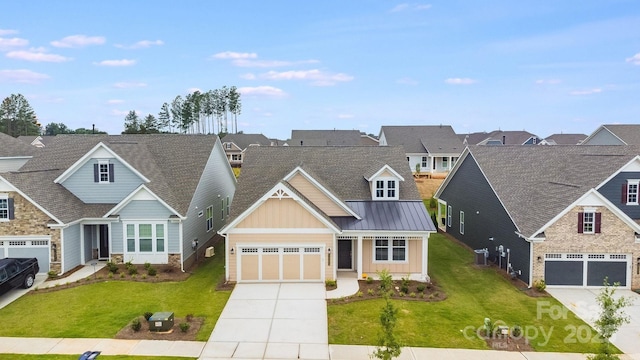 view of front of home with a standing seam roof, metal roof, concrete driveway, and a front yard