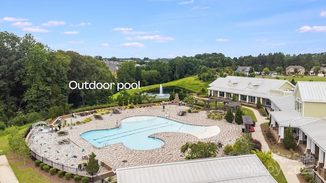 community pool featuring a patio area and a water view