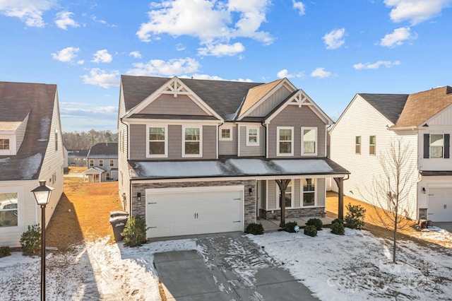 craftsman-style home featuring covered porch, stone siding, an attached garage, and driveway