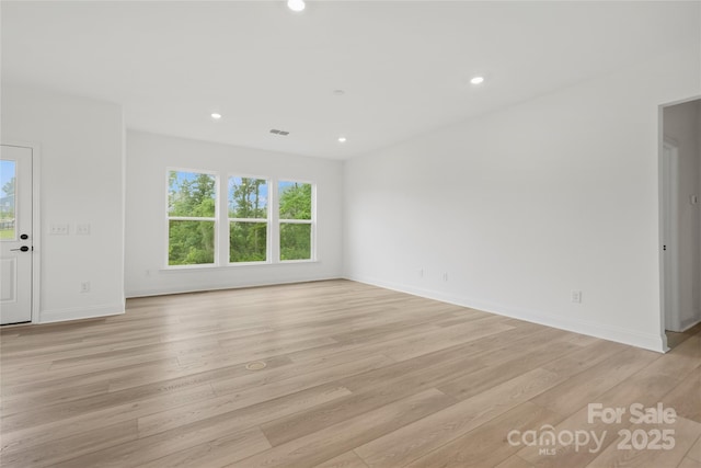 unfurnished living room featuring light wood-style floors, visible vents, baseboards, and recessed lighting