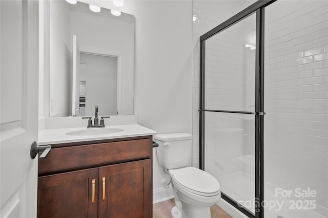 full bath featuring a stall shower, vanity, and toilet