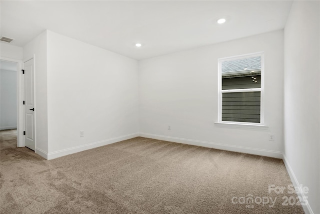 carpeted empty room featuring recessed lighting and baseboards