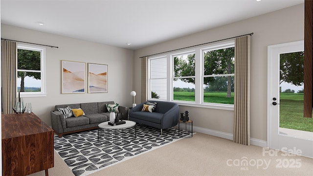 living room with carpet floors, a wealth of natural light, and baseboards