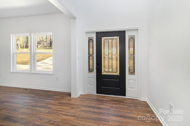 entrance foyer with dark wood finished floors and baseboards