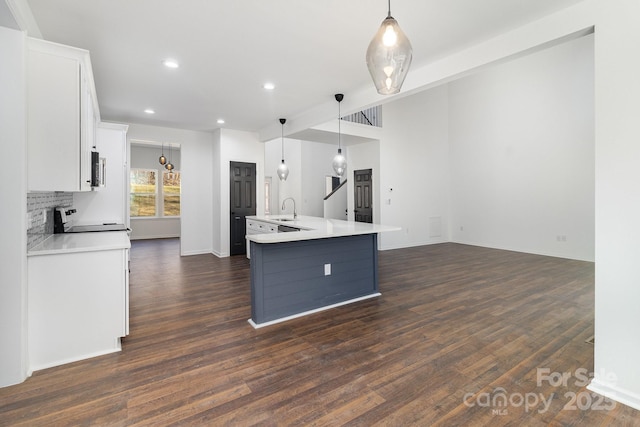 kitchen featuring light countertops, electric range, dark wood finished floors, and white cabinets