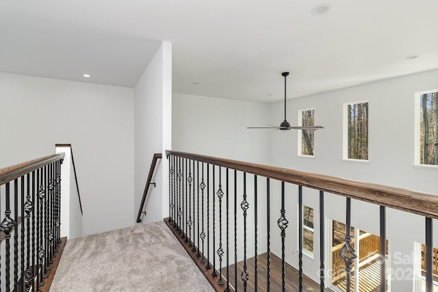 corridor with recessed lighting and an upstairs landing