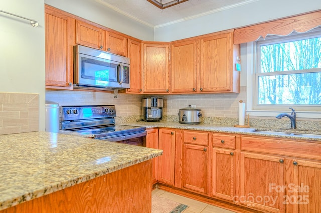 kitchen with range with electric cooktop, a sink, backsplash, stainless steel microwave, and crown molding