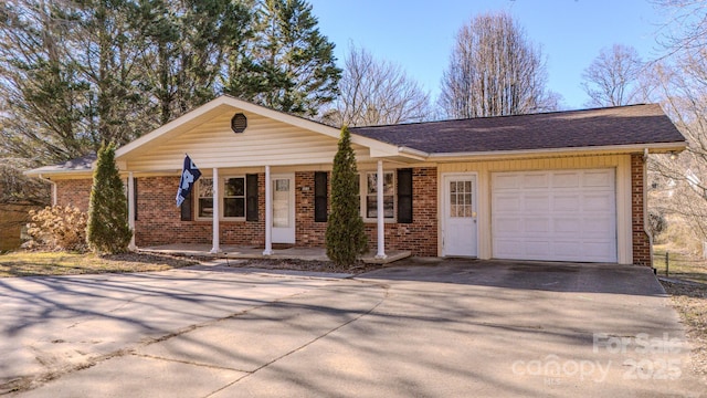 ranch-style home with an attached garage, covered porch, brick siding, a shingled roof, and concrete driveway