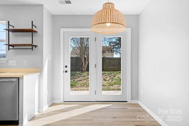 doorway to outside featuring light wood-type flooring and baseboards