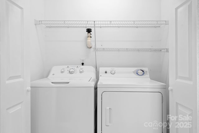 laundry room featuring washer and dryer and laundry area