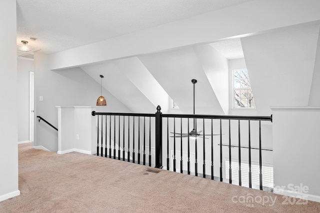 interior space with carpet flooring, a textured ceiling, and baseboards