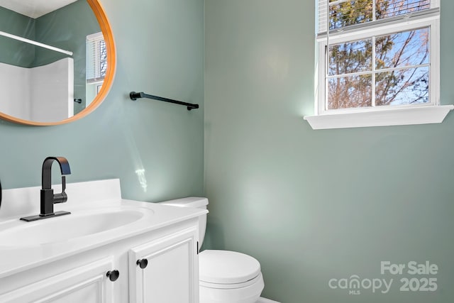 bathroom featuring vanity and toilet