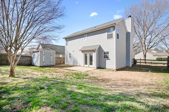 rear view of house with an outbuilding, a fenced backyard, a patio, and a shed