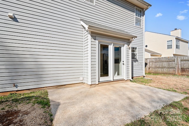 rear view of house featuring a patio area and fence