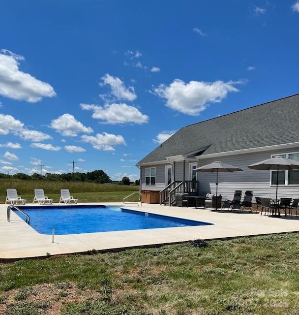 outdoor pool featuring a patio