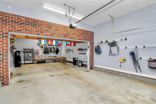 garage with a workshop area and a garage door opener