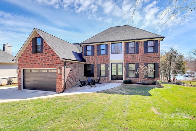 view of front of home featuring brick siding, a shingled roof, concrete driveway, a garage, and a front lawn