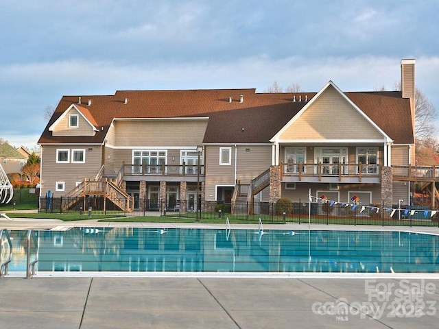 view of pool with a patio area, stairway, a fenced in pool, and fence