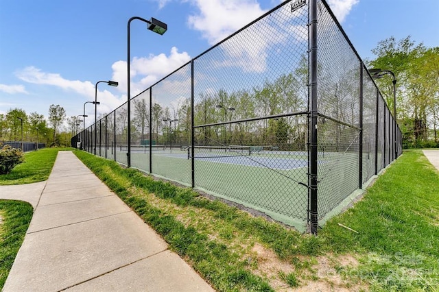 view of sport court with fence