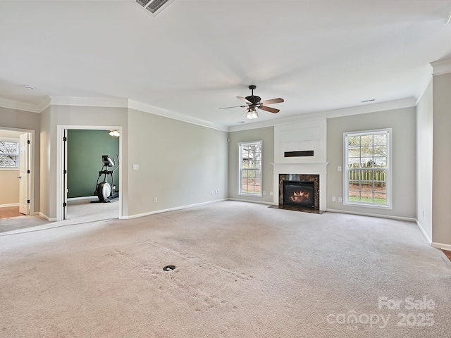 unfurnished living room featuring carpet flooring, a healthy amount of sunlight, a fireplace, and a ceiling fan