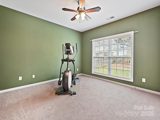 exercise area featuring visible vents, baseboards, a ceiling fan, and carpet floors