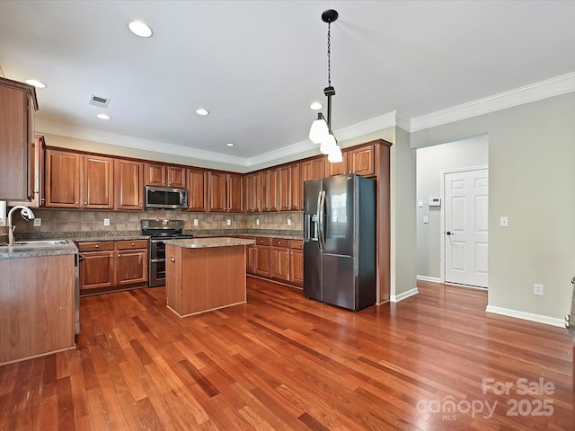 kitchen with visible vents, dark wood finished floors, a center island, stainless steel appliances, and decorative backsplash