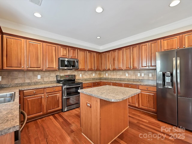 kitchen featuring decorative backsplash, crown molding, dark wood-style floors, and stainless steel appliances