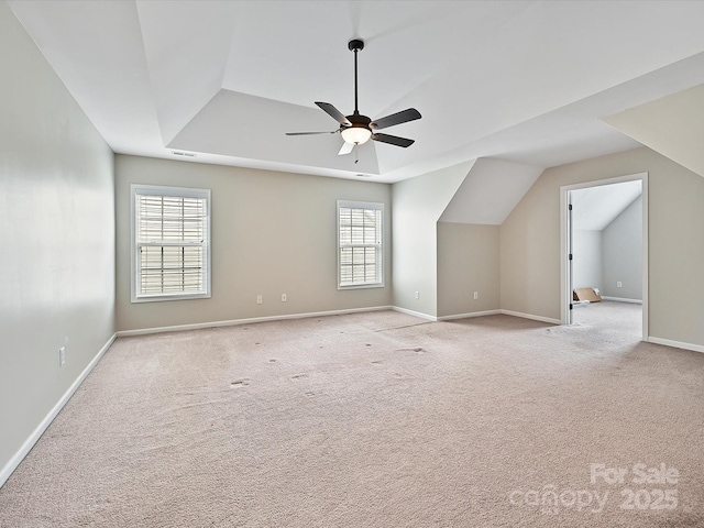 additional living space with lofted ceiling, carpet, baseboards, and ceiling fan