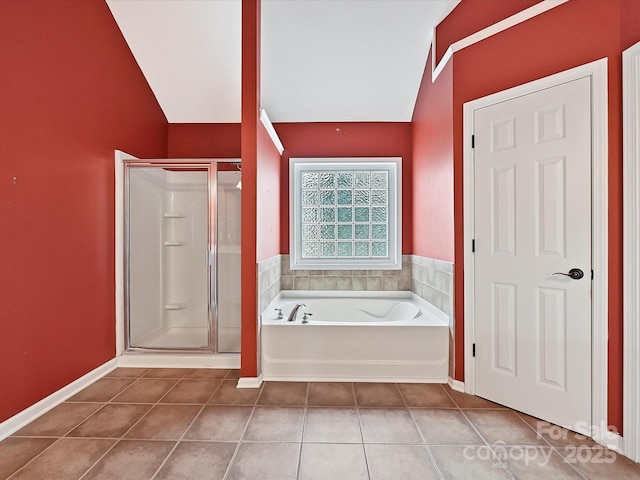 bathroom with tile patterned flooring, lofted ceiling, a bath, and a stall shower