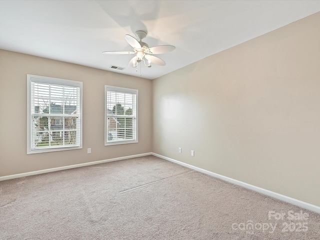 unfurnished room featuring visible vents, baseboards, carpet, and a ceiling fan