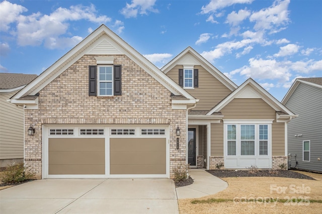 craftsman-style home with driveway, a garage, and brick siding