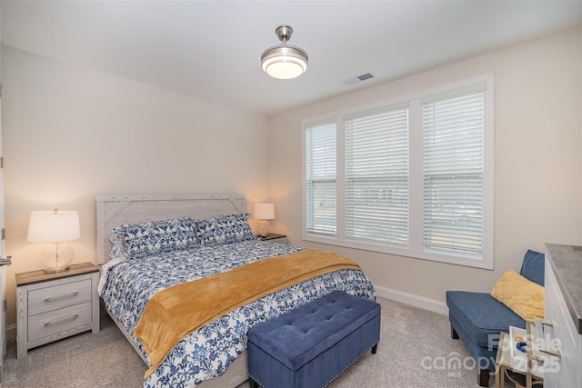 carpeted bedroom with visible vents and baseboards