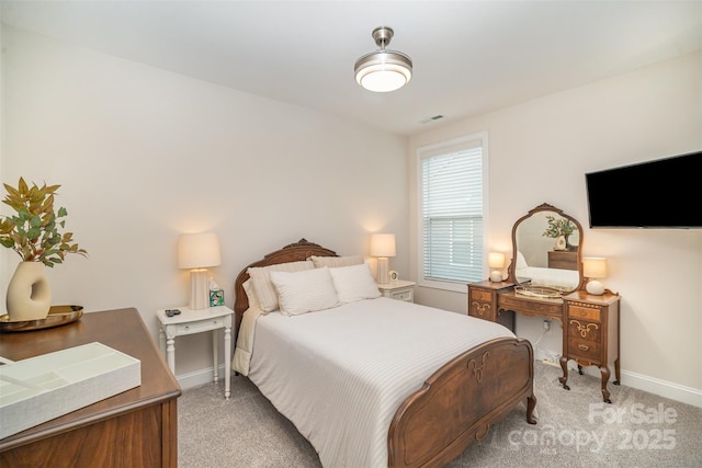 bedroom with light carpet, visible vents, and baseboards