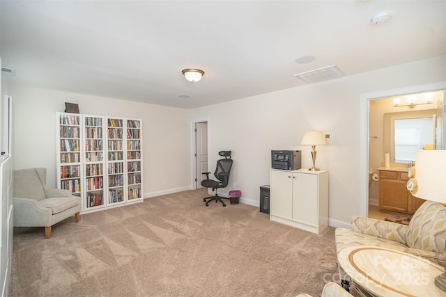 sitting room featuring light carpet, visible vents, and baseboards