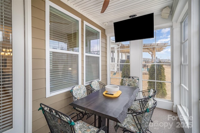 sunroom / solarium featuring wood ceiling