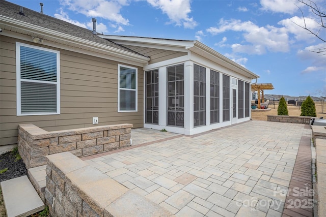 view of patio / terrace featuring a sunroom