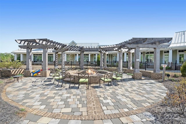 view of home's community with a fire pit, a patio, fence, and a pergola