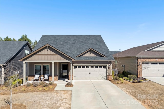 craftsman-style home featuring a porch, a garage, a shingled roof, brick siding, and driveway