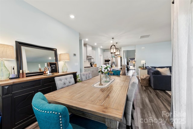 dining space with an inviting chandelier, visible vents, wood finished floors, and recessed lighting