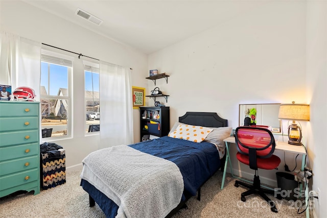 carpeted bedroom featuring visible vents and baseboards