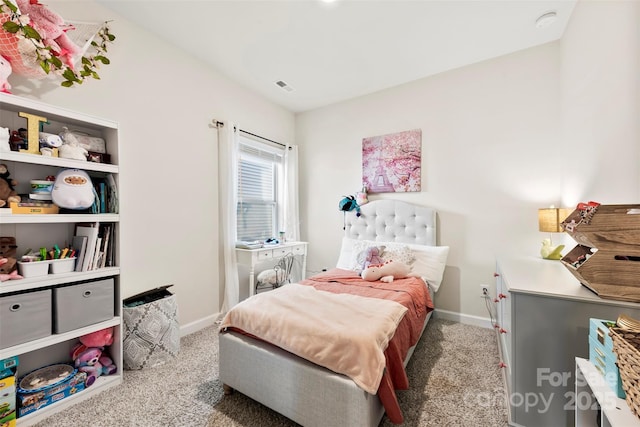 carpeted bedroom with visible vents and baseboards