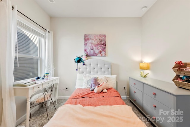 carpeted bedroom featuring baseboards