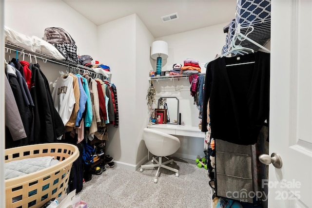 walk in closet featuring visible vents and carpet flooring